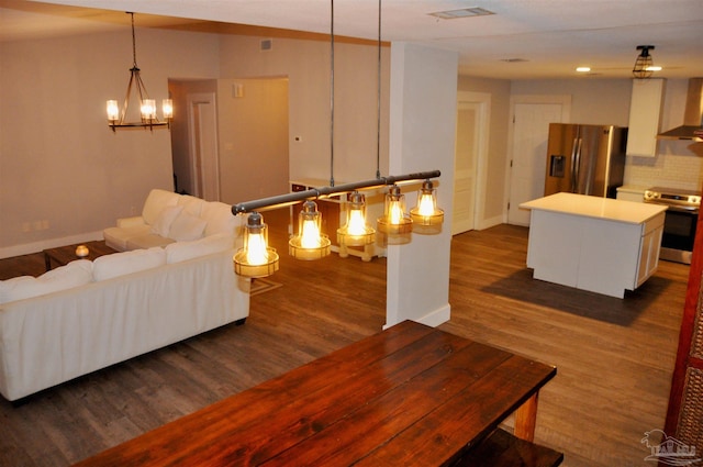 living room featuring dark hardwood / wood-style floors and a notable chandelier