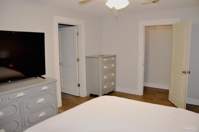 bedroom with dark hardwood / wood-style floors and ceiling fan