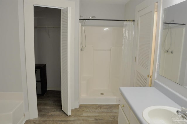 bathroom with hardwood / wood-style floors, vanity, and a shower with shower curtain