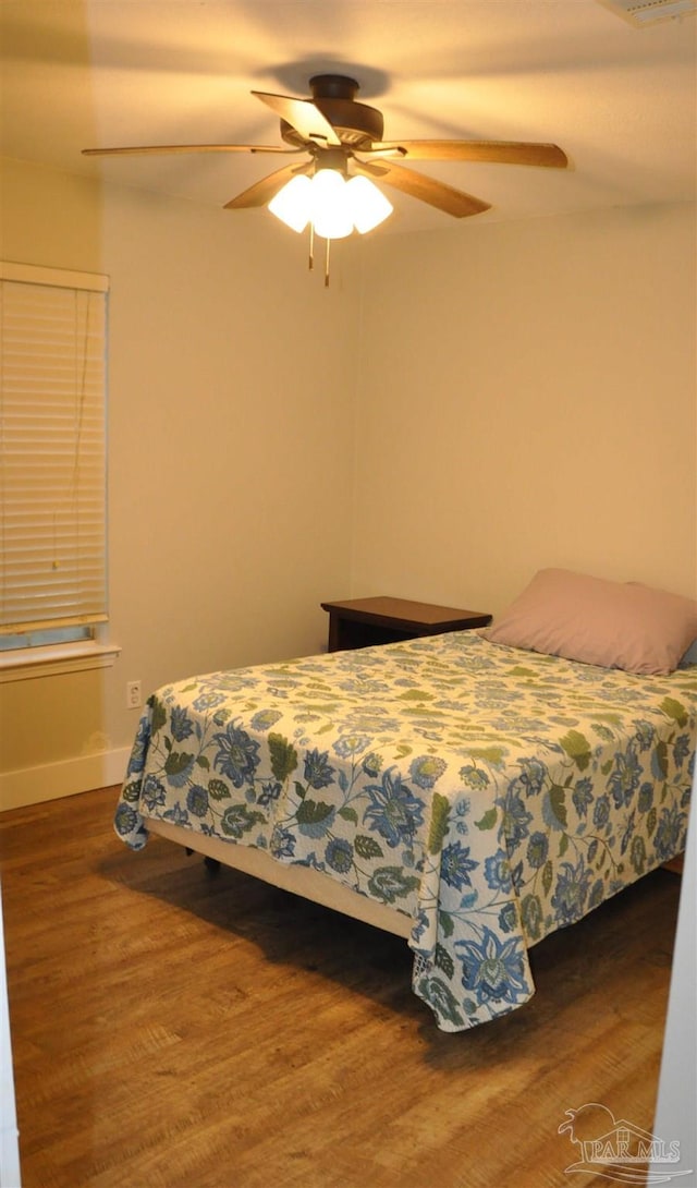 bedroom featuring ceiling fan and dark hardwood / wood-style flooring