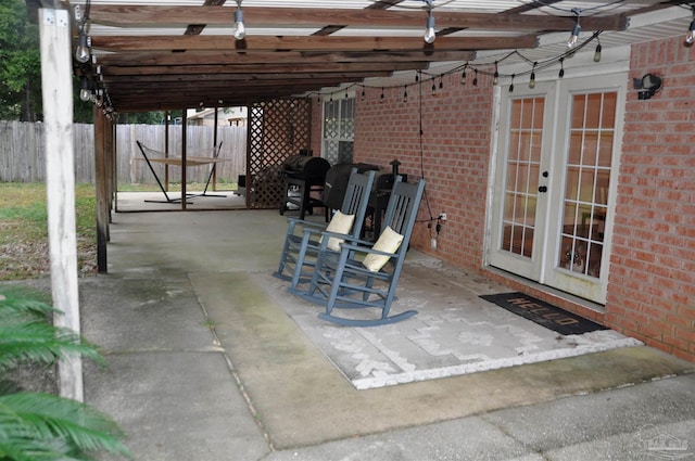 view of patio / terrace featuring french doors, a pergola, and a grill