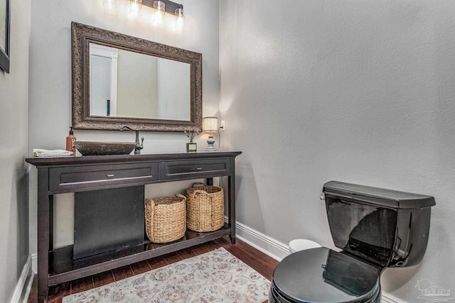 bathroom featuring hardwood / wood-style flooring, vanity, and toilet