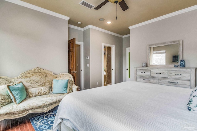 bedroom with crown molding, hardwood / wood-style flooring, and ceiling fan