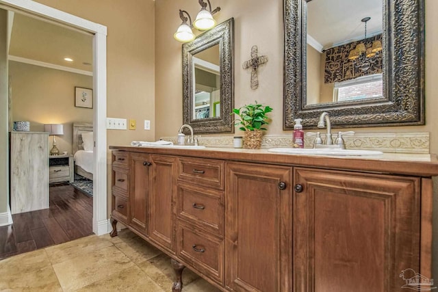 bathroom with ornamental molding and vanity