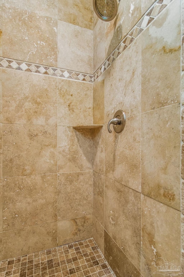 interior details with a tile shower