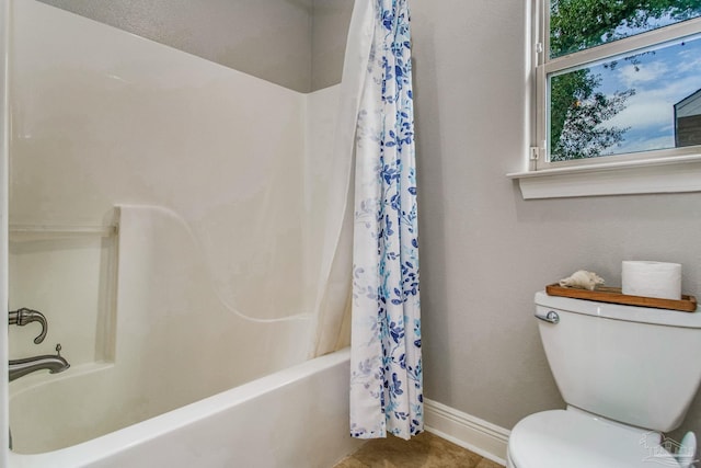 bathroom with toilet, tile patterned flooring, and shower / tub combo