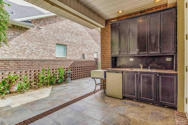 view of patio with a wet bar and an outdoor kitchen