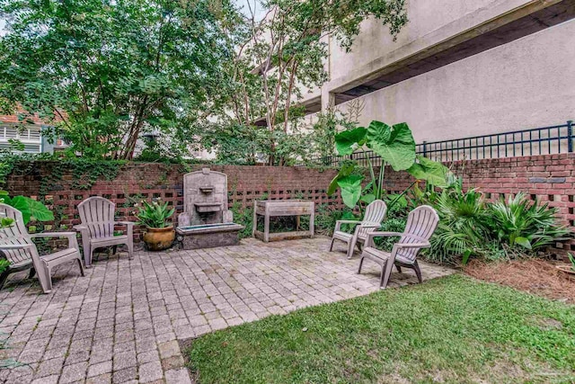 view of patio / terrace featuring exterior fireplace