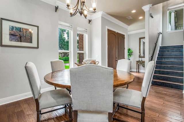 dining space with crown molding, a chandelier, and dark hardwood / wood-style flooring