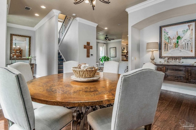 dining room featuring dark hardwood / wood-style flooring, ornamental molding, and a chandelier