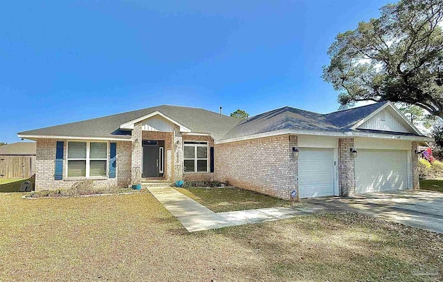 single story home featuring a front yard, concrete driveway, brick siding, and an attached garage