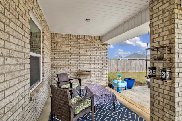 view of patio featuring fence