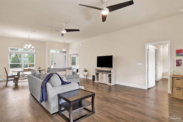 living room featuring dark wood-style floors, plenty of natural light, and ceiling fan with notable chandelier