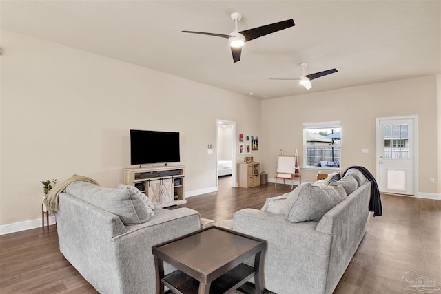 living room with dark wood-type flooring, baseboards, and a ceiling fan