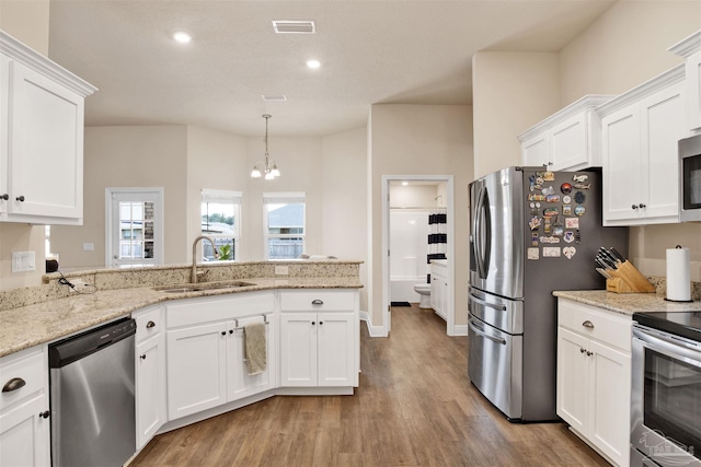 kitchen with white cabinets, stainless steel appliances, and a sink