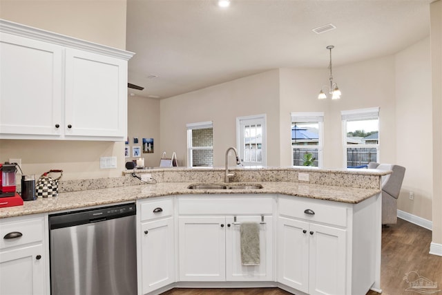 kitchen featuring visible vents, white cabinets, dishwasher, a peninsula, and a sink