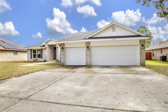 ranch-style house featuring brick siding, an attached garage, a front yard, cooling unit, and driveway