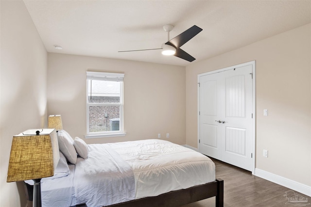 bedroom with ceiling fan, baseboards, and wood finished floors