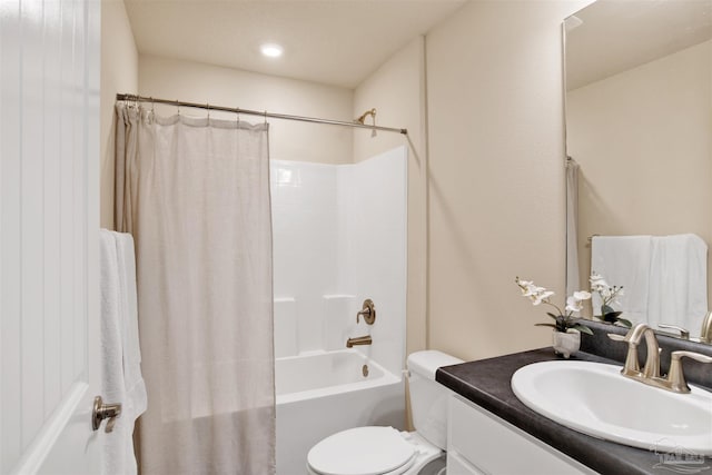 bathroom featuring toilet, shower / bath combo, and vanity