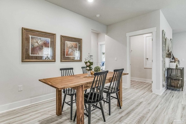 9777 Windy Hill Rd, Pensacola, FL 32526 - dining room featuring light wood-style flooring and baseboards