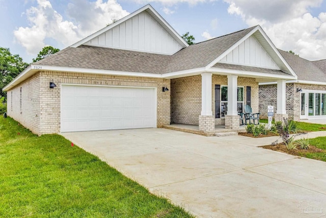 9777 Windy Hill Rd, Pensacola, FL 32526 - craftsman inspired home with board and batten siding, brick siding, a porch, and driveway