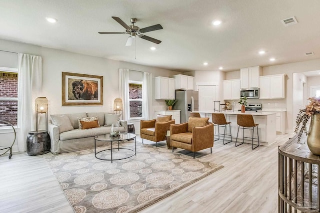 9777 Windy Hill Rd, Pensacola, FL 32526 - living room featuring plenty of natural light, ceiling fan, light wood-style floors, and recessed lighting