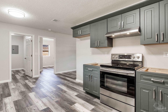 7125 Ben Sasser Dr, Pensacola, FL 32526 - kitchen featuring stainless steel electric stove, under cabinet range hood, electric panel, light wood-style flooring, and a textured ceiling