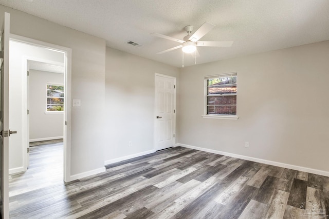 7125 Ben Sasser Dr, Pensacola, FL 32526 - spare room featuring a ceiling fan, wood finished floors, and a textured ceiling