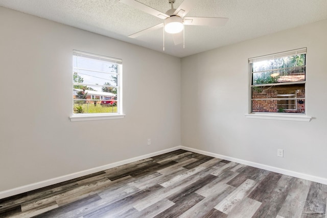 7125 Ben Sasser Dr, Pensacola, FL 32526 - empty room with wood finished floors, a ceiling fan, plenty of natural light, and a textured ceiling