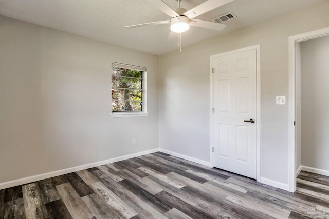 7125 Ben Sasser Dr, Pensacola, FL 32526 - spare room with a ceiling fan, wood finished floors, and a textured ceiling