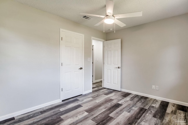 7125 Ben Sasser Dr, Pensacola, FL 32526 - unfurnished bedroom featuring wood finished floors, a textured ceiling, and ceiling fan