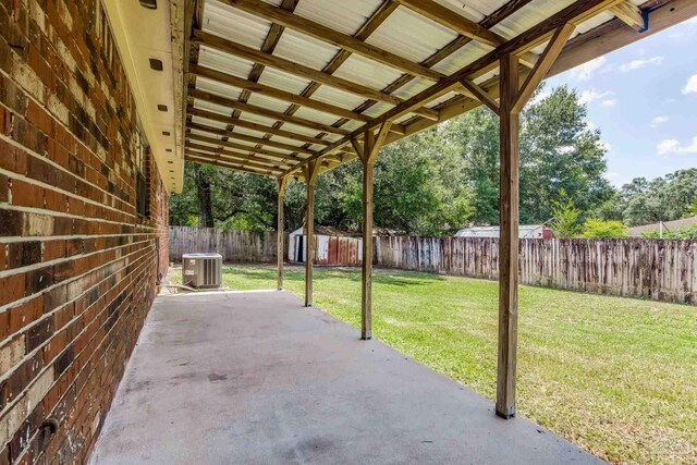 7125 Ben Sasser Dr, Pensacola, FL 32526 - fenced backyard with a storage unit and a patio