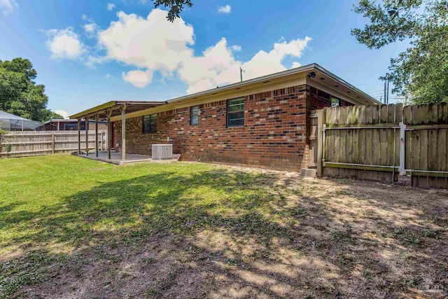 7125 Ben Sasser Dr, Pensacola, FL 32526 - rear view of property with brick siding, a fenced backyard, and a patio