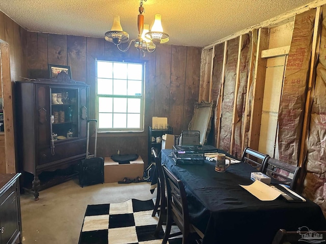 2939 Sundance Ln, Cantonment, FL 32533 - dining room featuring a chandelier, wooden walls, and a textured ceiling