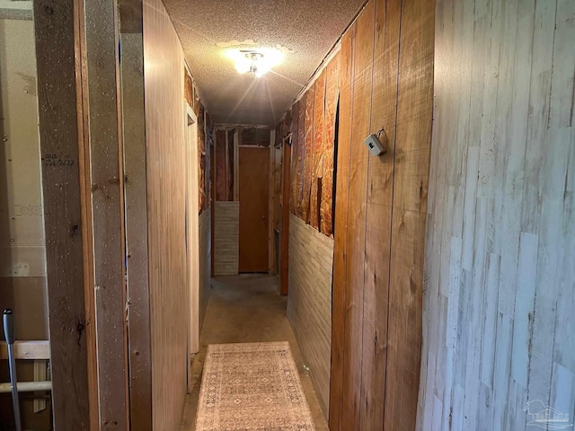2939 Sundance Ln, Cantonment, FL 32533 - corridor featuring wooden walls and a textured ceiling
