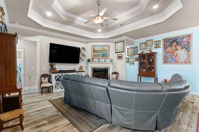 2420 Okatie Ln, Cantonment, FL 32533 - living area featuring visible vents, ceiling fan, crown molding, a fireplace, and a raised ceiling