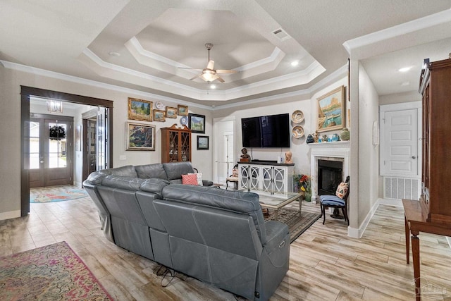 2420 Okatie Ln, Cantonment, FL 32533 - living area with a raised ceiling, visible vents, ornamental molding, a fireplace, and ceiling fan
