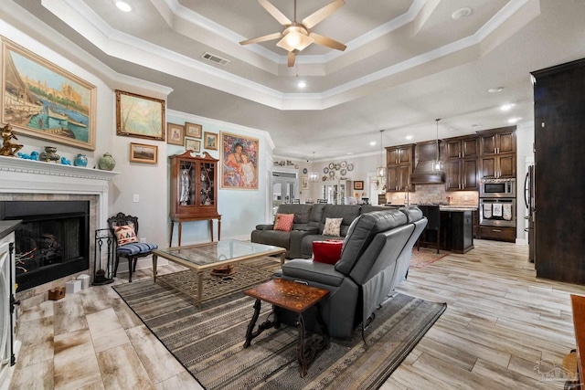 2420 Okatie Ln, Cantonment, FL 32533 - living area with a tray ceiling, visible vents, ceiling fan, a fireplace, and ornamental molding