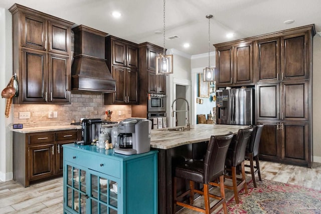 2420 Okatie Ln, Cantonment, FL 32533 - kitchen featuring a sink, visible vents, backsplash, stainless steel refrigerator with ice dispenser, and premium range hood