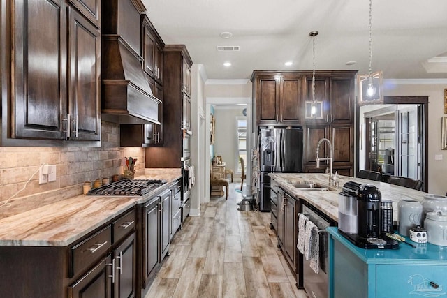 2420 Okatie Ln, Cantonment, FL 32533 - kitchen featuring visible vents, a sink, crown molding, dark brown cabinetry, and custom range hood