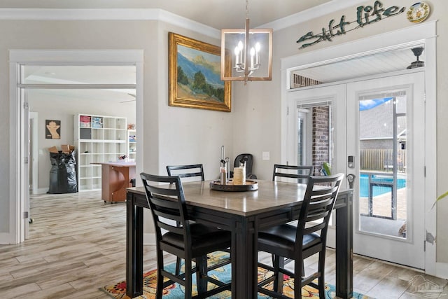 2420 Okatie Ln, Cantonment, FL 32533 - dining area with a notable chandelier, french doors, and light wood-type flooring