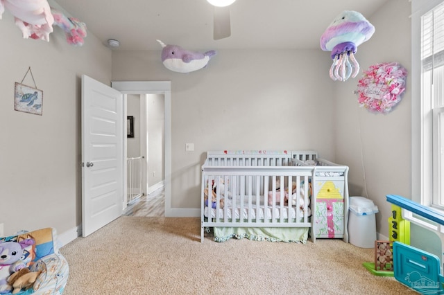 2420 Okatie Ln, Cantonment, FL 32533 - bedroom with ceiling fan, carpet floors, a crib, and baseboards