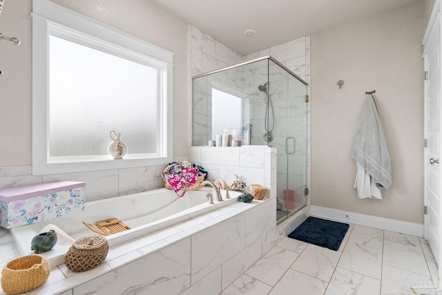 2420 Okatie Ln, Cantonment, FL 32533 - bathroom with a bath, a shower stall, marble finish floor, and baseboards