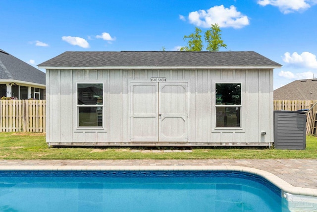 2420 Okatie Ln, Cantonment, FL 32533 - view of swimming pool with fence, a fenced in pool, an outdoor structure, and a storage shed