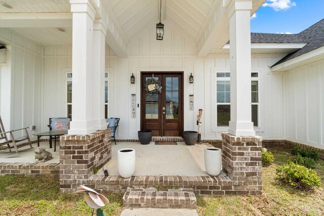 2420 Okatie Ln, Cantonment, FL 32533 - view of exterior entry with board and batten siding and a porch