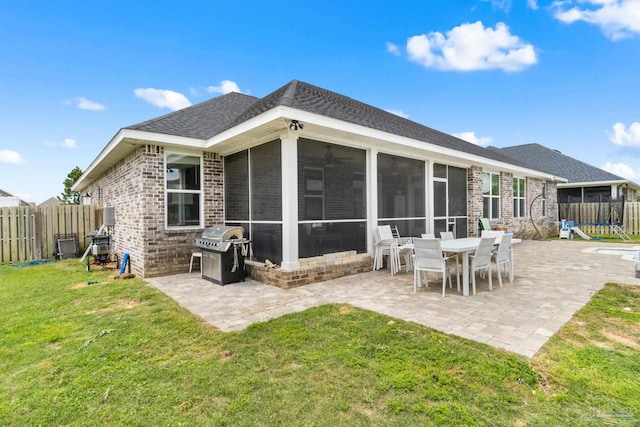 2420 Okatie Ln, Cantonment, FL 32533 - rear view of house with brick siding, a yard, a sunroom, and a patio