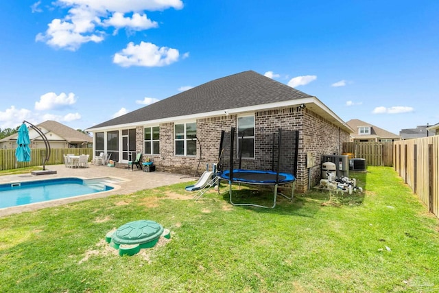 2420 Okatie Ln, Cantonment, FL 32533 - back of house with a fenced backyard, brick siding, a trampoline, a yard, and a patio