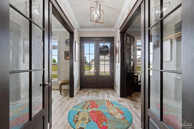 2420 Okatie Ln, Cantonment, FL 32533 - entryway with wood finished floors, french doors, crown molding, baseboards, and a chandelier