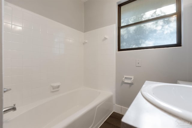 bathroom with bathing tub / shower combination and sink