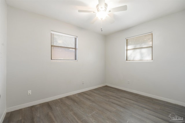 empty room featuring ceiling fan and dark hardwood / wood-style flooring